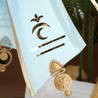 Gold earring with a decorative design on a light blue card with a logo. Rolecosplay Wuthering Waves Iuno Cosplay Costume